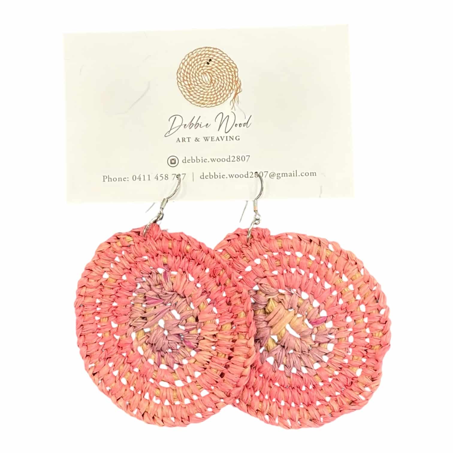 Sunset Glow handwoven earrings by Gomeroi artist Debbie Wood. Large, circular raffia earrings in warm sunset hues for a natural, elegant style.