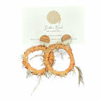 Embrace nature with Ethereal Earth Handwoven Earrings, featuring raffia and emu feathers for a delicate, grounded look.