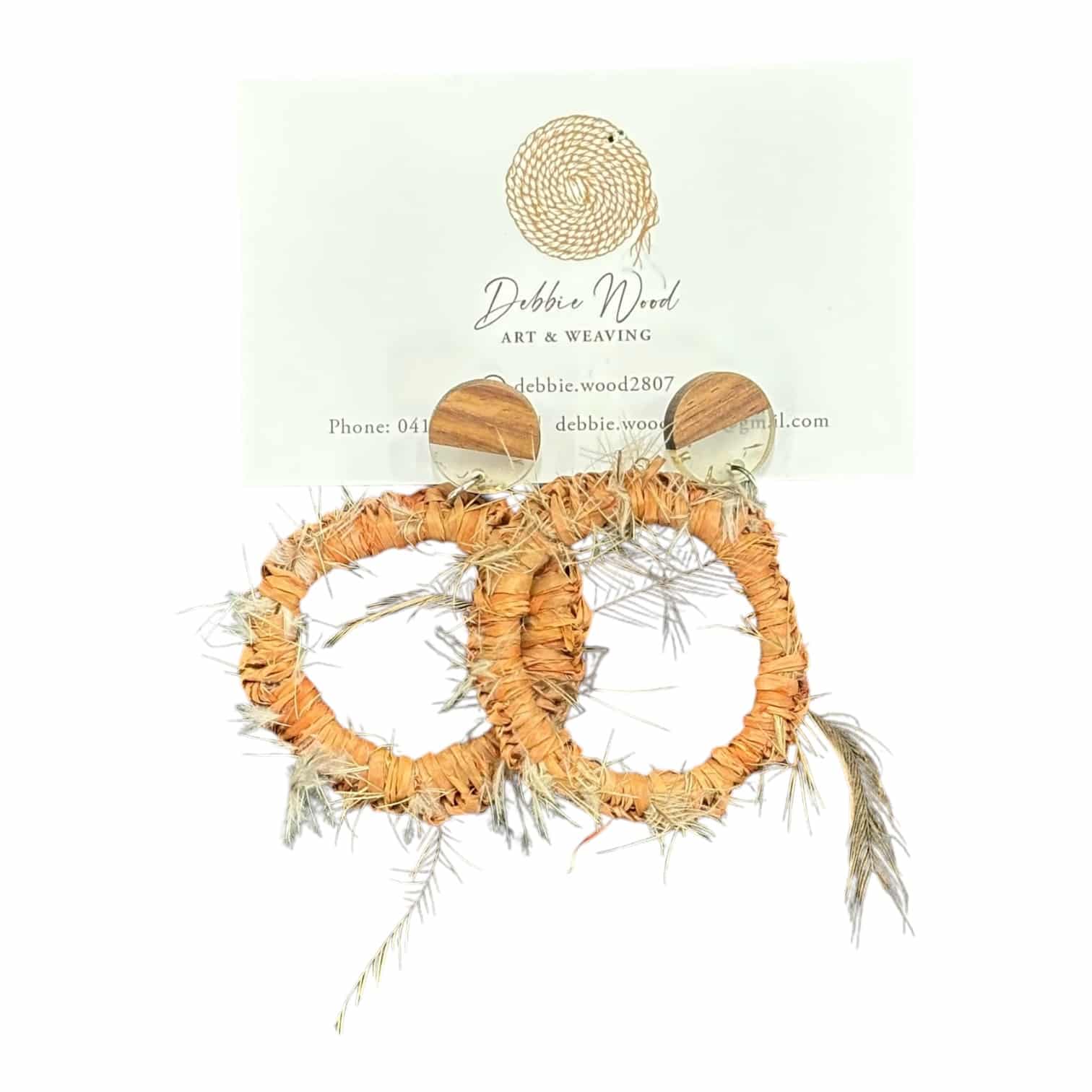 Embrace nature with Ethereal Earth Handwoven Earrings, featuring raffia and emu feathers for a delicate, grounded look.