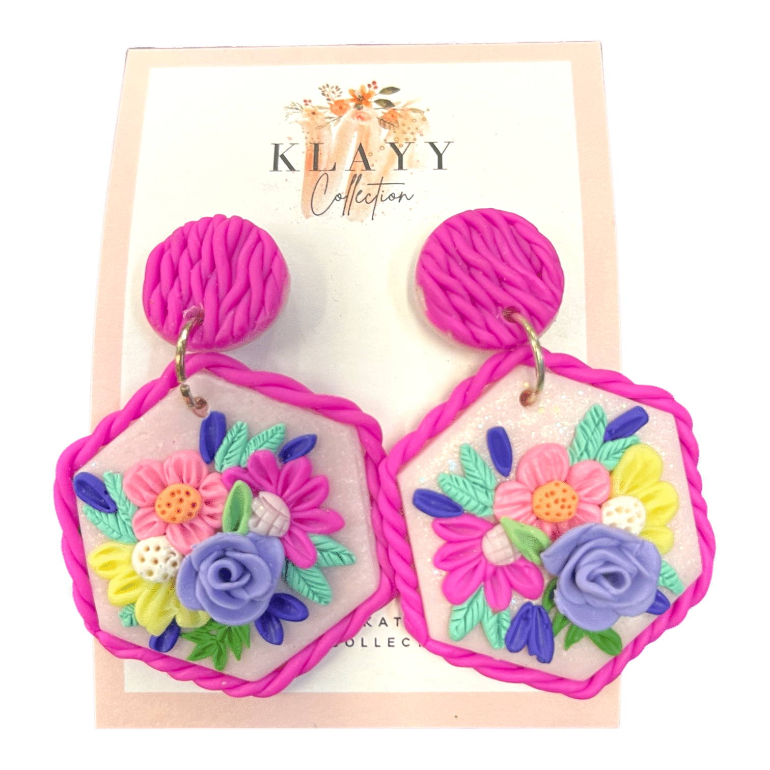 Bold in Bloom earrings feature bright floral designs and hand-twisted details in playful pinks and purples. Handmade in polymer clay.