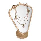 The Sakura Blossom Necklace by Art In Stone Jewellery features rose quartz flowers, soft pink tones, and gold accents, inspired by cherry blossoms.