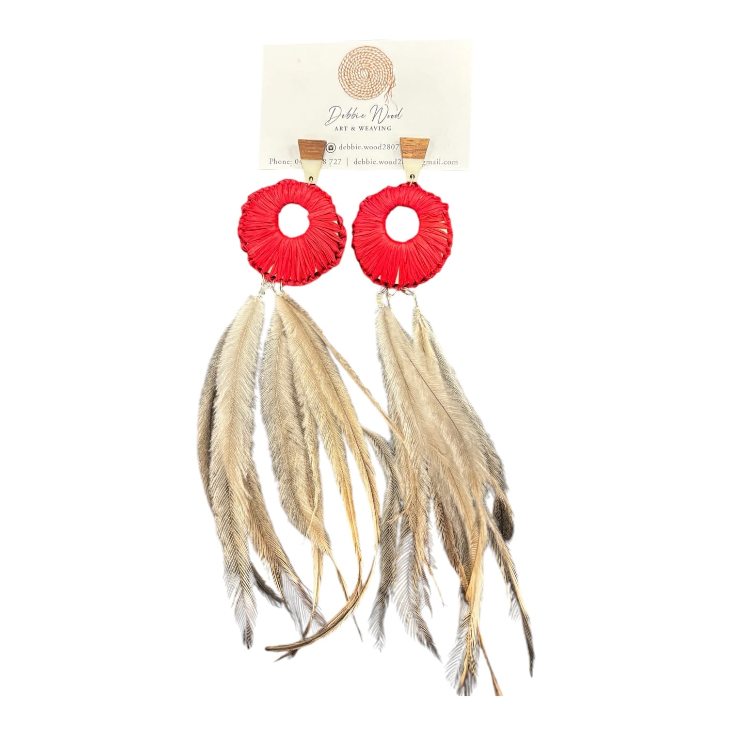 Bring a burst of vibrant orange with the Bright Horizon Earrings by Debbie Wood. Raffia and emu feathers create a bold, sunny look for any occasion.