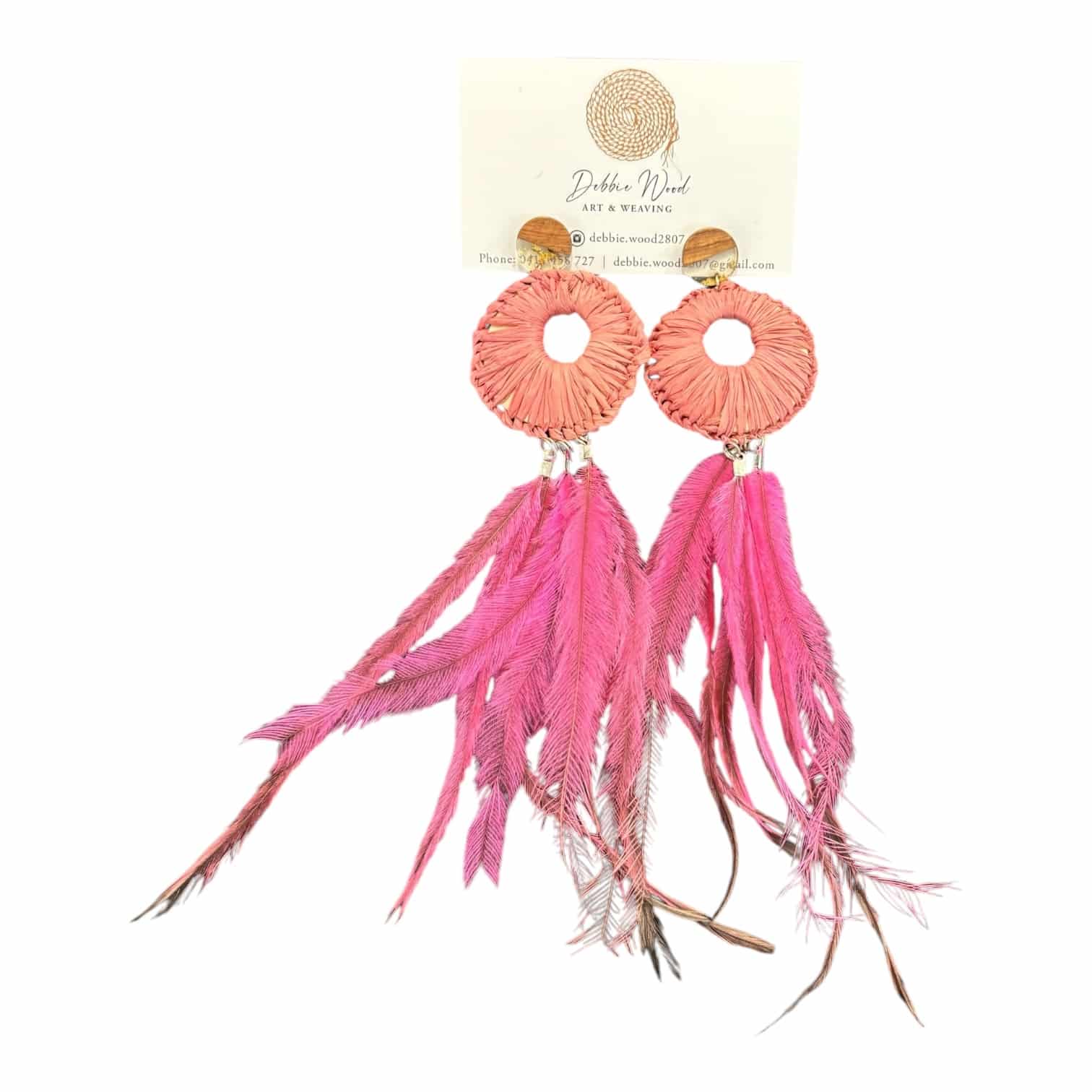 Embrace the beauty of nature with the Wildflower Breeze Earrings by Debbie Wood featuring handwoven pink raffia and soft emu feathers.