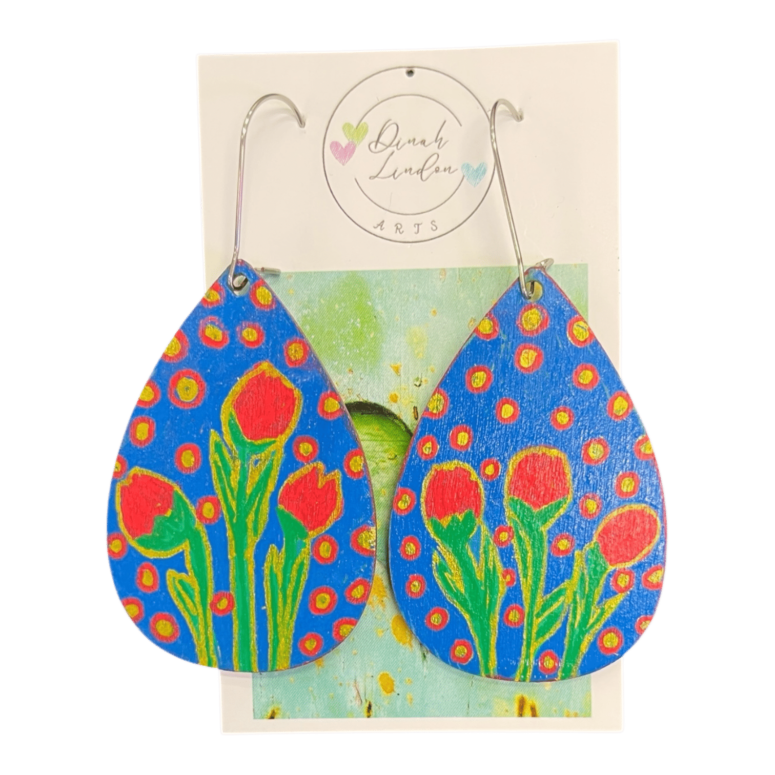 Garden Party Drops by Dinah Lindon – vibrant teardrop earrings with red tulips and golden dots on a bold blue background.