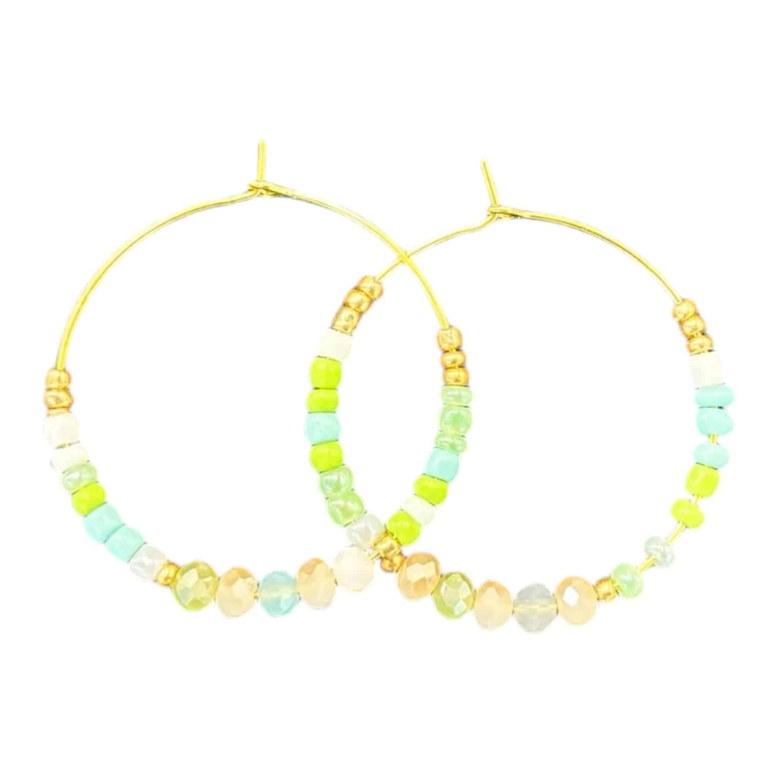Celebrate spring with these handmade Spring Meadow Hoops, featuring vibrant green and blue crystals, inspired by fresh blooms.