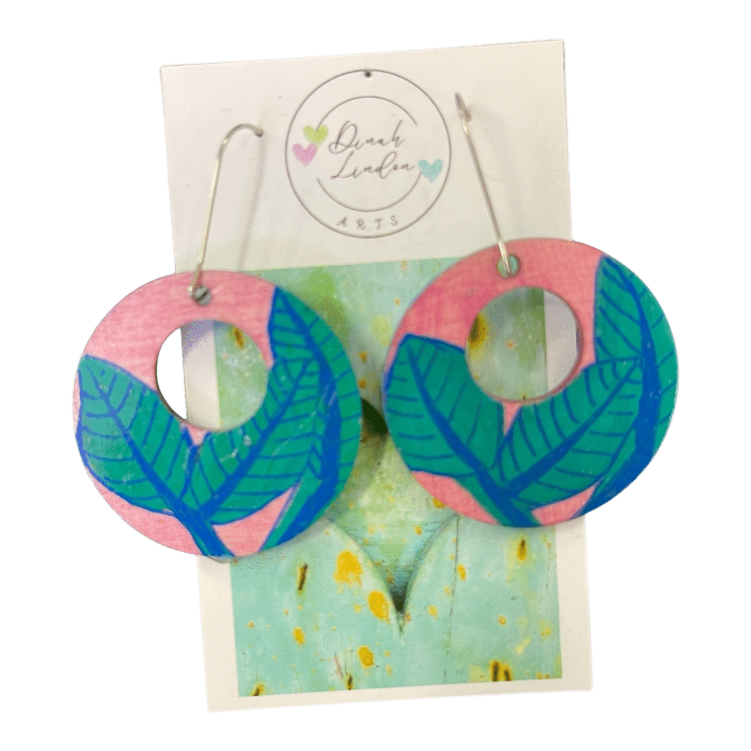 Tropical Leaf Loops by Dinah Lindon – bold round earrings handpainted with lush green foliage on a playful pink background.