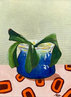 "Golden Series – Phoebe" by Maggie Deall is a modern oil painting of a blue vase with greenery, set against a gold-leaf background. Framed in oak.