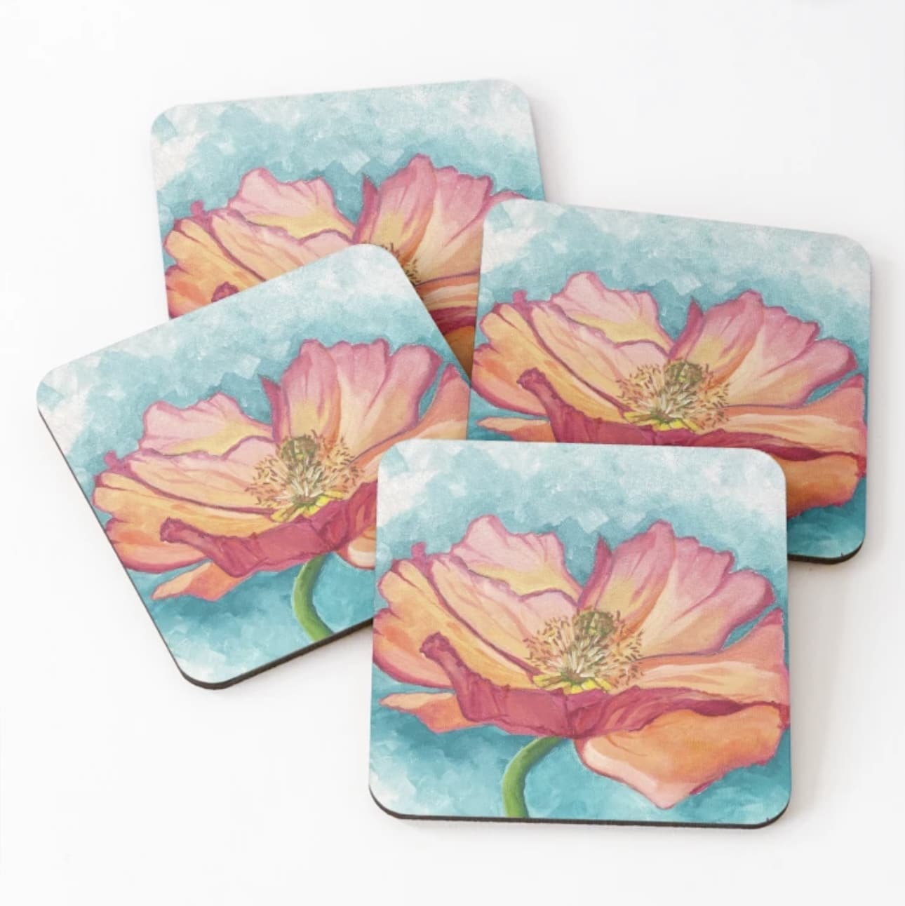Liven up your table with Maggie Deall’s floral coaster set, featuring vibrant pink and peach flowers on a blue background. Art and functionality combined!