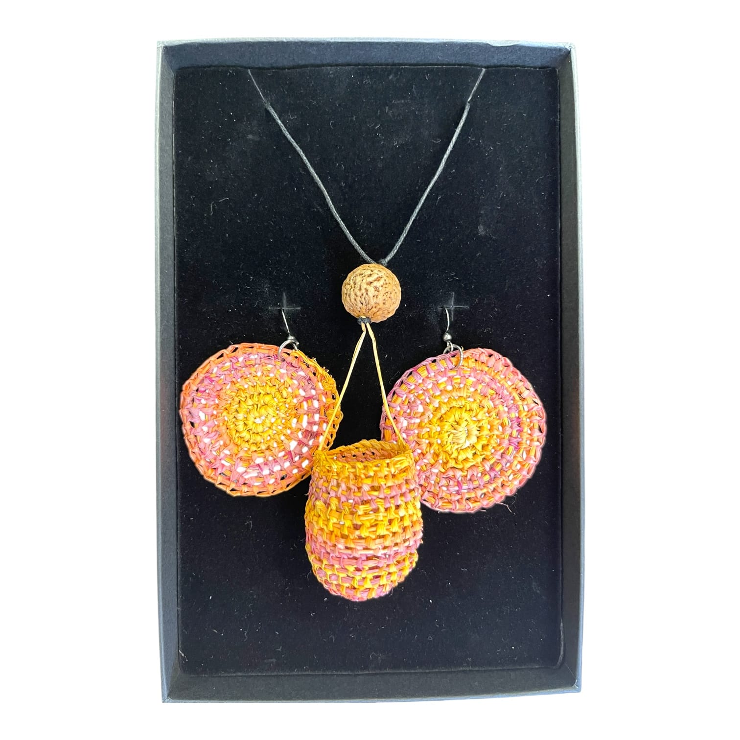 Desert Sunset Set by Gomeroi artist Debbie Wood. A bright raffia basket necklace with matching earrings in sunset pinks and yellow.