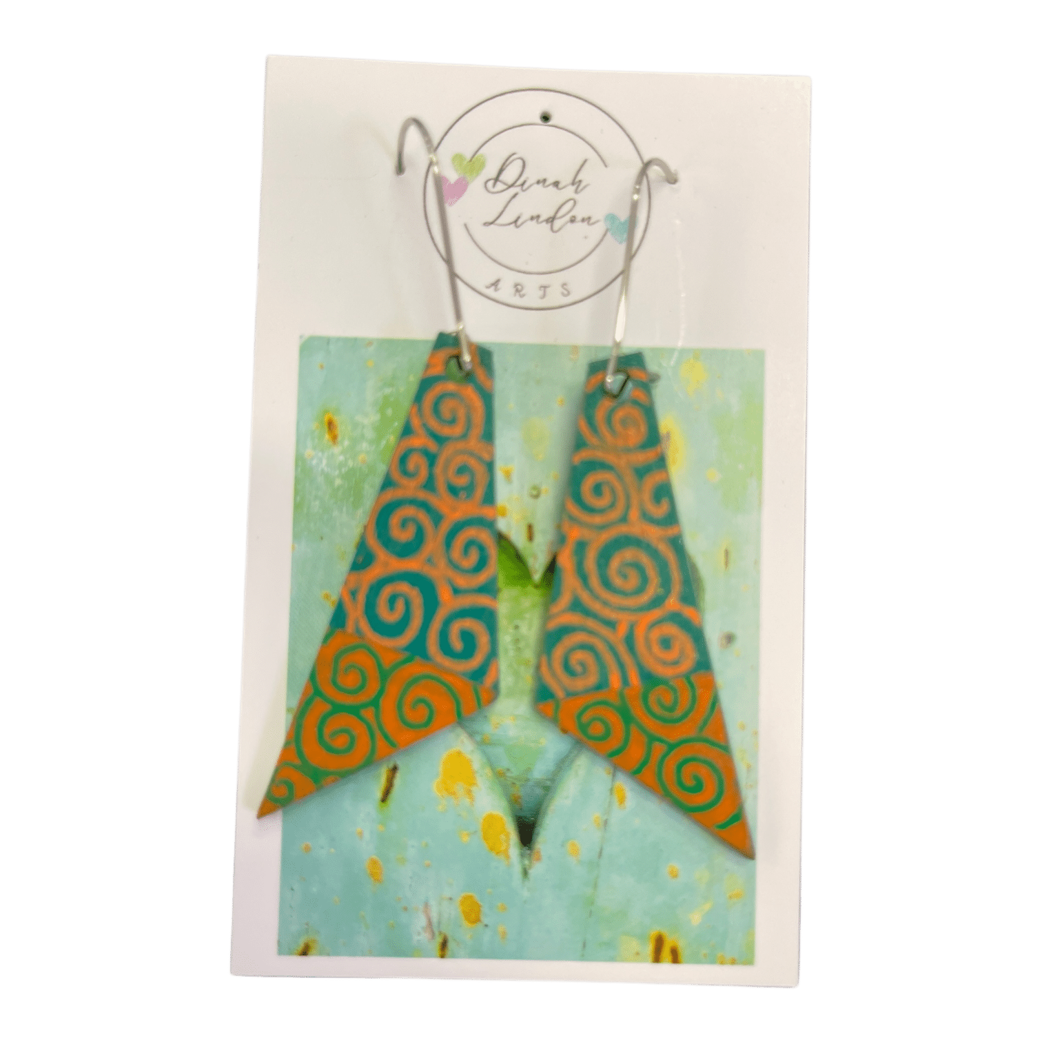 Desert Spiral Arrows – orange and teal arrowhead earrings with handpainted spiral patterns and a glossy finish by Dinah Lindon.