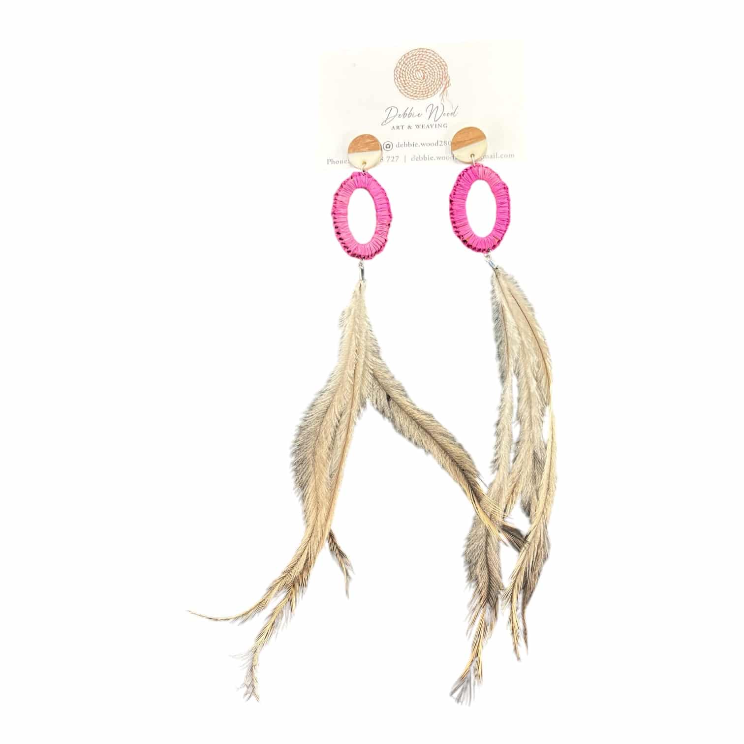 Add a touch of vibrant colour with Debbie Wood's "Pink Sunset" earrings, featuring handwoven pink raffia and ethically sourced emu feathers. Playful, bold, and elegant.