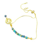 Ocean Swirl Bracelet by Art in Stone — handmade with crystals, semi-precious stones, CZ accents, and a golden swirl charm. Adjustable and one of a kind!