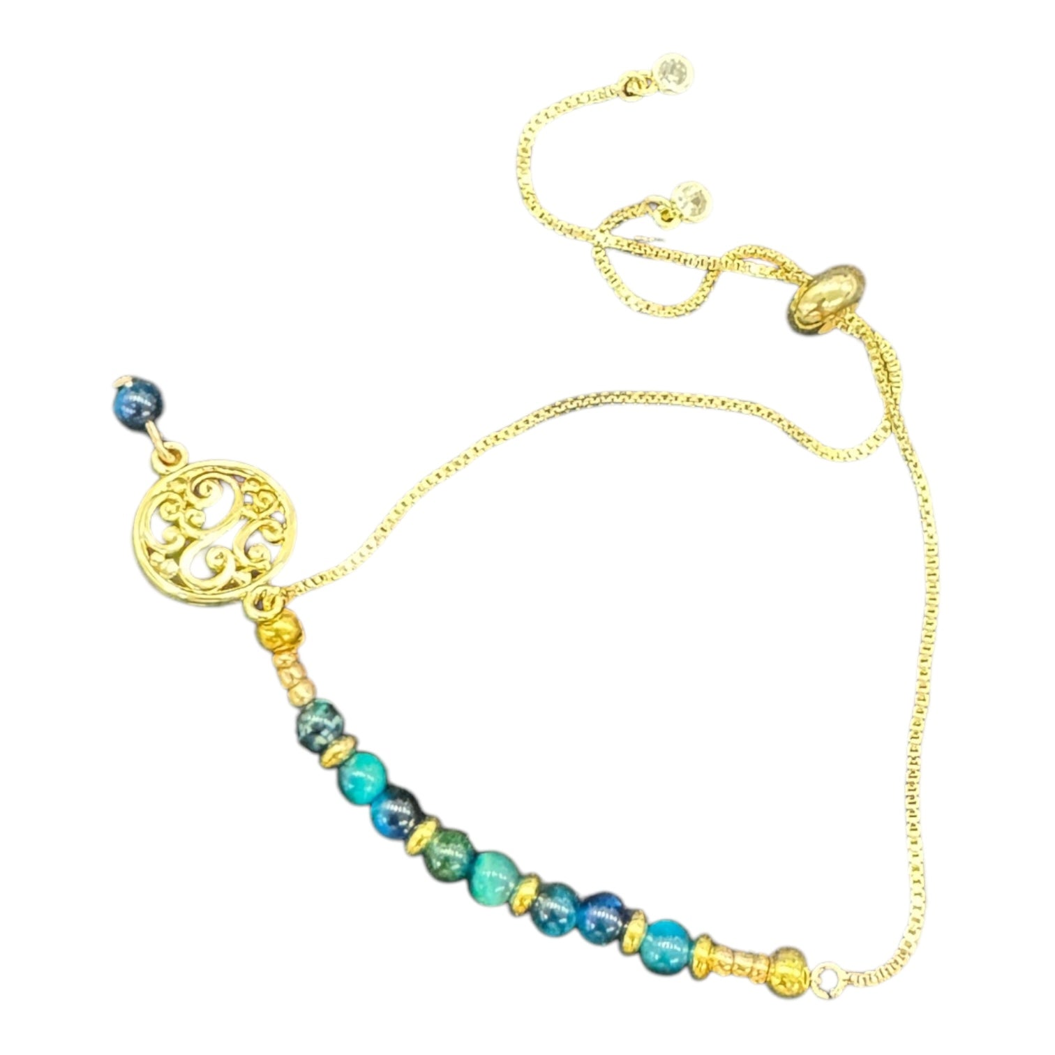 Ocean Swirl Bracelet by Art in Stone — handmade with crystals, semi-precious stones, CZ accents, and a golden swirl charm. Adjustable and one of a kind!