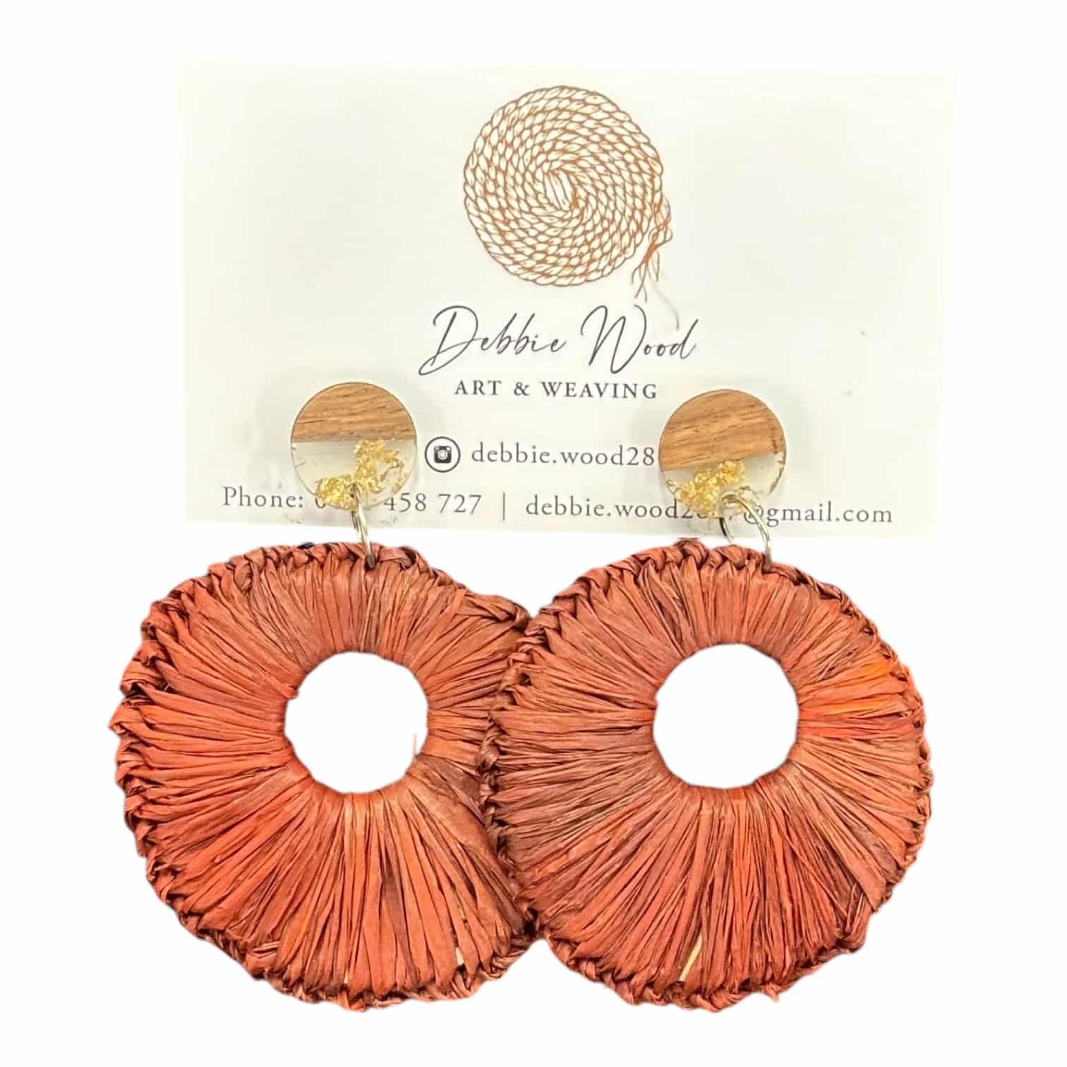 Sunset Aura Handwoven Earrings Description: Drawing inspiration from warm sunset hues, the "Sunset Aura" handwoven earrings blend soft orange tones in a round raffia design. Handcrafted by Gomeroi artist Debbie Wood, these earrings capture the beauty of dusk and are perfect for evening outings or adding warmth to your style.