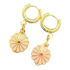 Bring the sunshine with Pretty in Pink Daisy Huggies — soft blush flowers on gold hoops for everyday fun and charm.
