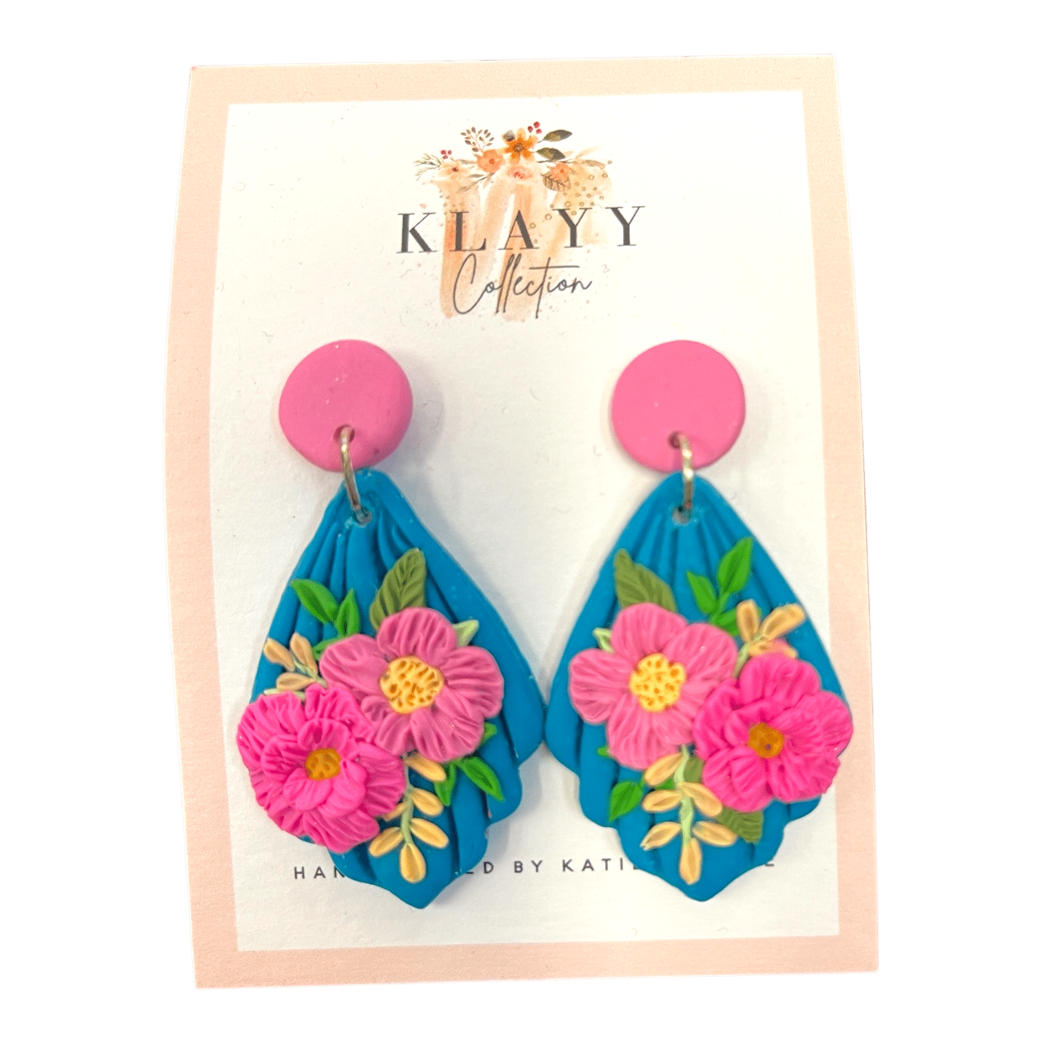 Island Bouquet earrings feature hot pink blooms on vivid blue with candy-pink studs. Bright, bold, and beach-ready.