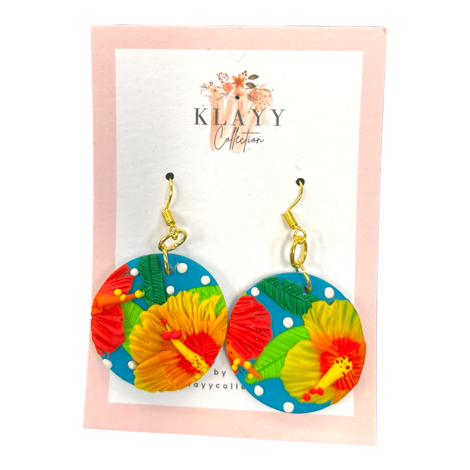 Tropicana Dots earrings showcase tropical florals on teal clay with white polka dots. Handmade fun for summer lovers.