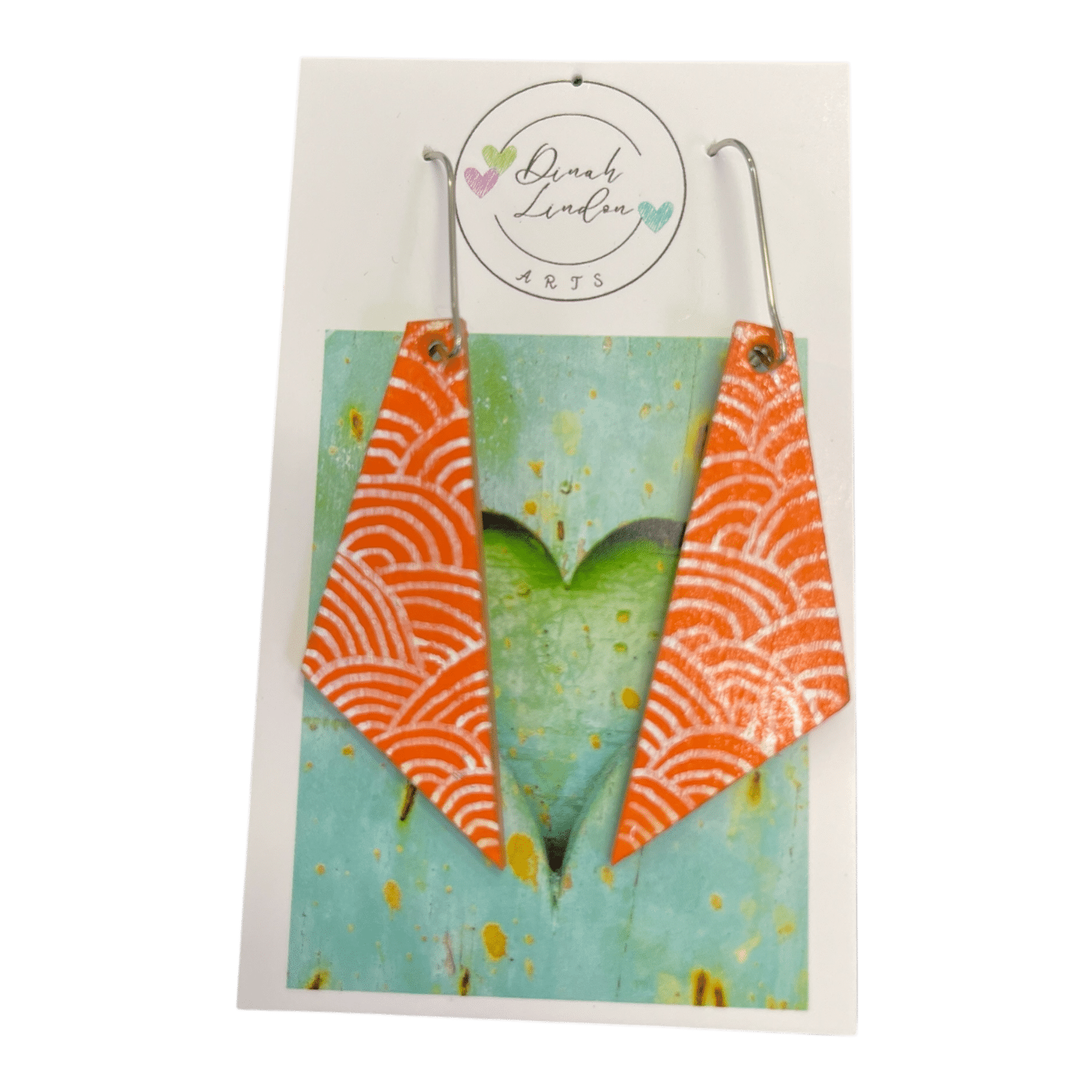 Coral Wave Arrows – bright coral earrings with white wave patterns in a sharp, angled shape.