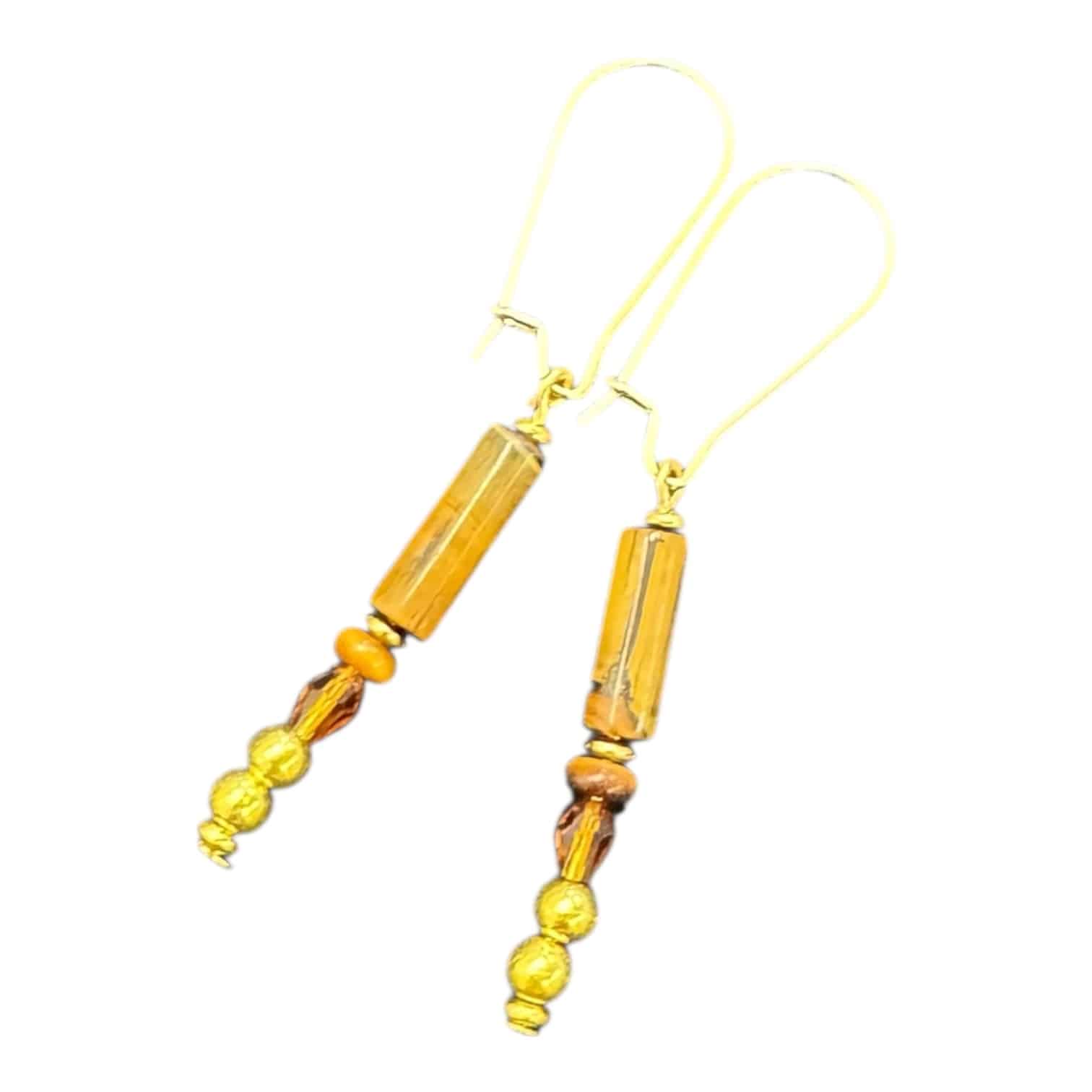 Amber Solstice Dangles by Art in Stone — handmade gold and amber crystal earrings inspired by golden light and artisan craftsmanship.