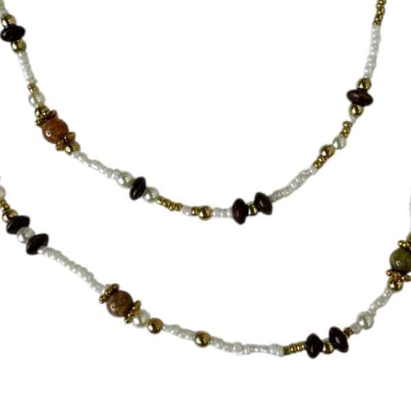 The Midnight Ember Necklace by Art in Stone Jewellery is a handmade double-strand piece featuring onyx, amber, and smoky quartz gemstones, accented with gold and pearls—perfect for elegant layering.