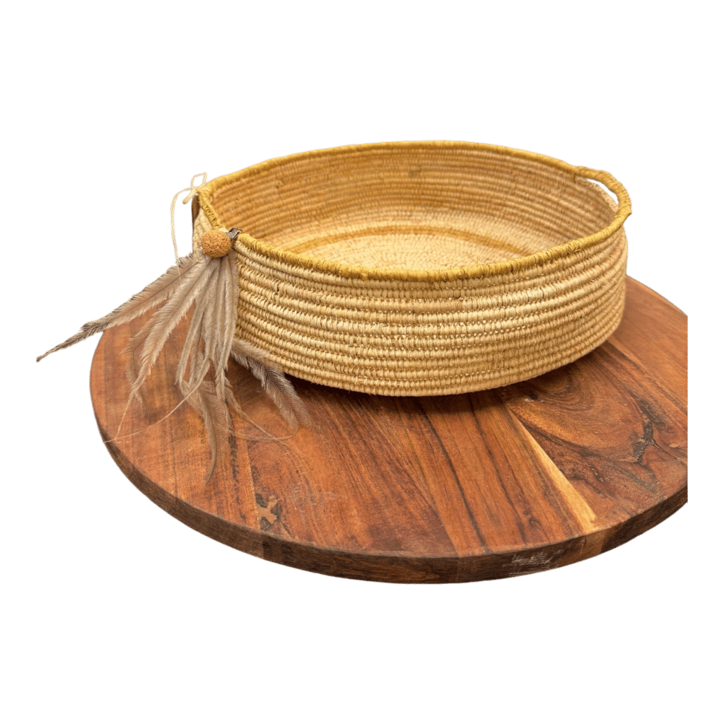 Celebrate cultural heritage with the "Emu Spirit Basket," a traditionally woven basket by Gomeroi artist Debbie Wood. Part of "The NAIDOC Collection," this piece features natural raffia and emu feathers, embodying artistic tradition and natural beauty.