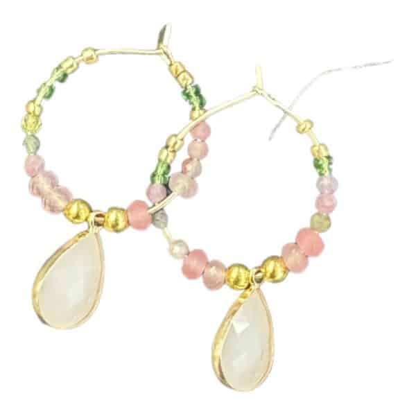 Add a touch of romance with Blushing Rose earrings by Maggie Deall. Features soft pink and green beads with an elegant teardrop charm.