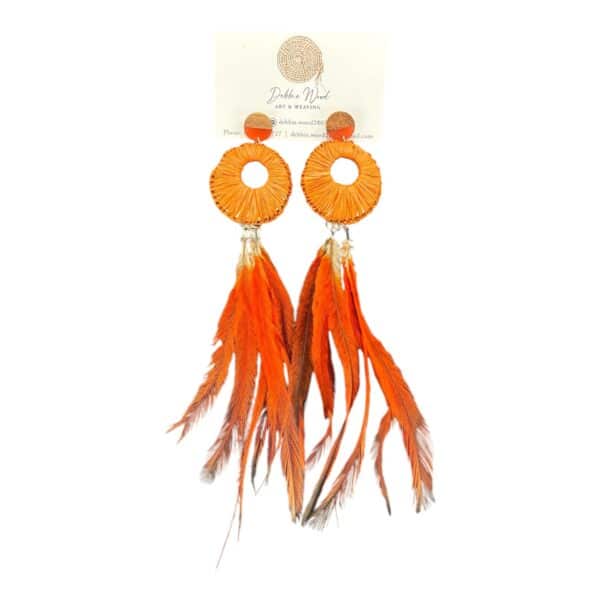 Light up your look with the Ember Dance Earrings by Gomeroi artist Debbie Wood, featuring red raffia and ethically sourced emu feathers. Perfect for bold, statement-making style.