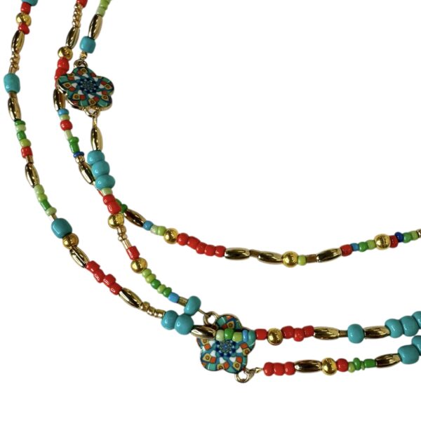 Bright and bold, the Fiesta Spirit Necklace by Art In Stone Jewellery features turquoise, coral, and gold accents with handcrafted floral enamel details.