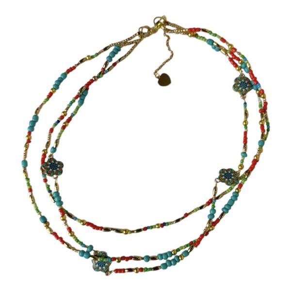 Bright and bold, the Fiesta Spirit Necklace by Art In Stone Jewellery features turquoise, coral, and gold accents with handcrafted floral enamel details.