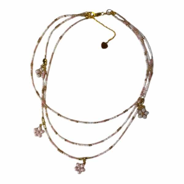 The Sakura Blossom Necklace by Art In Stone Jewellery features rose quartz flowers, soft pink tones, and gold accents, inspired by cherry blossoms.