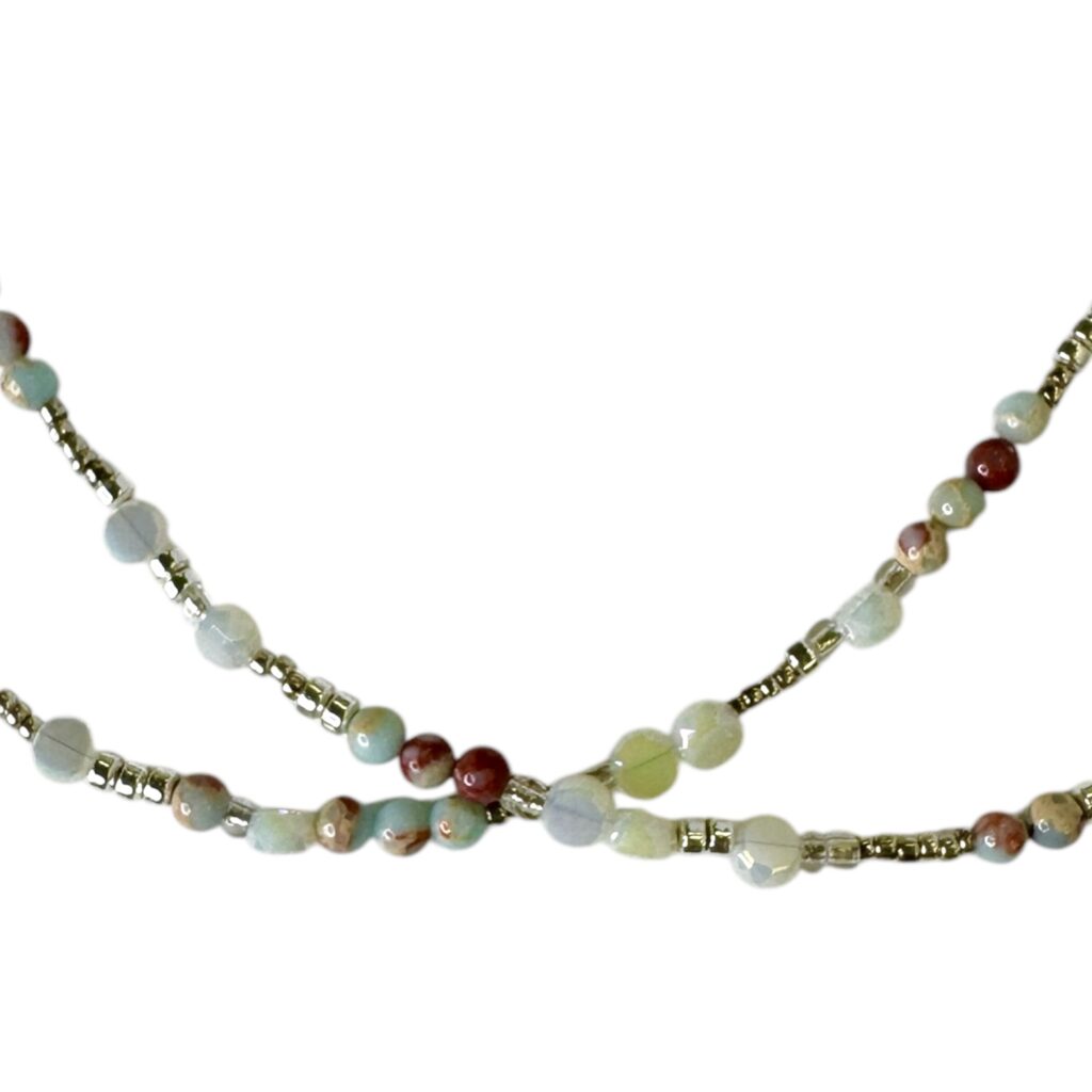 The Whispering Sands Necklace by Art In Stone Jewellery features Amazonite gemstones, soft neutrals, and sterling silver accents, inspired by desert tones.
