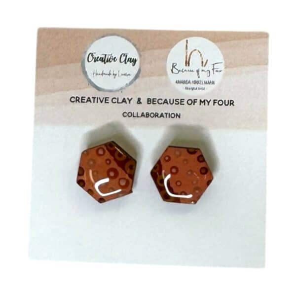 Ginny 15mm Hexagon Studs 5 are rust-toned handmade earrings featuring Amanda Hinkelmann’s circle artwork in resin and clay.