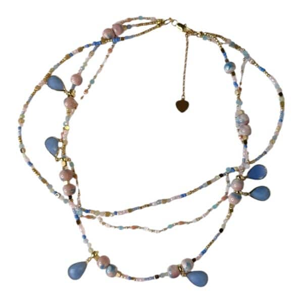 Handmade Ocean Breeze Necklace featuring blue chalcedony teardrops, blush pink beads, and gold accents. A delicate, ocean-inspired piece by Art In Stone Jewellery.