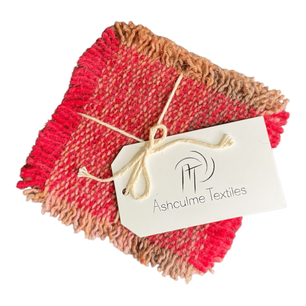 Warm pink and rust-toned coasters in alpaca and merino wool. Handwoven and naturally dyed. Set of four.