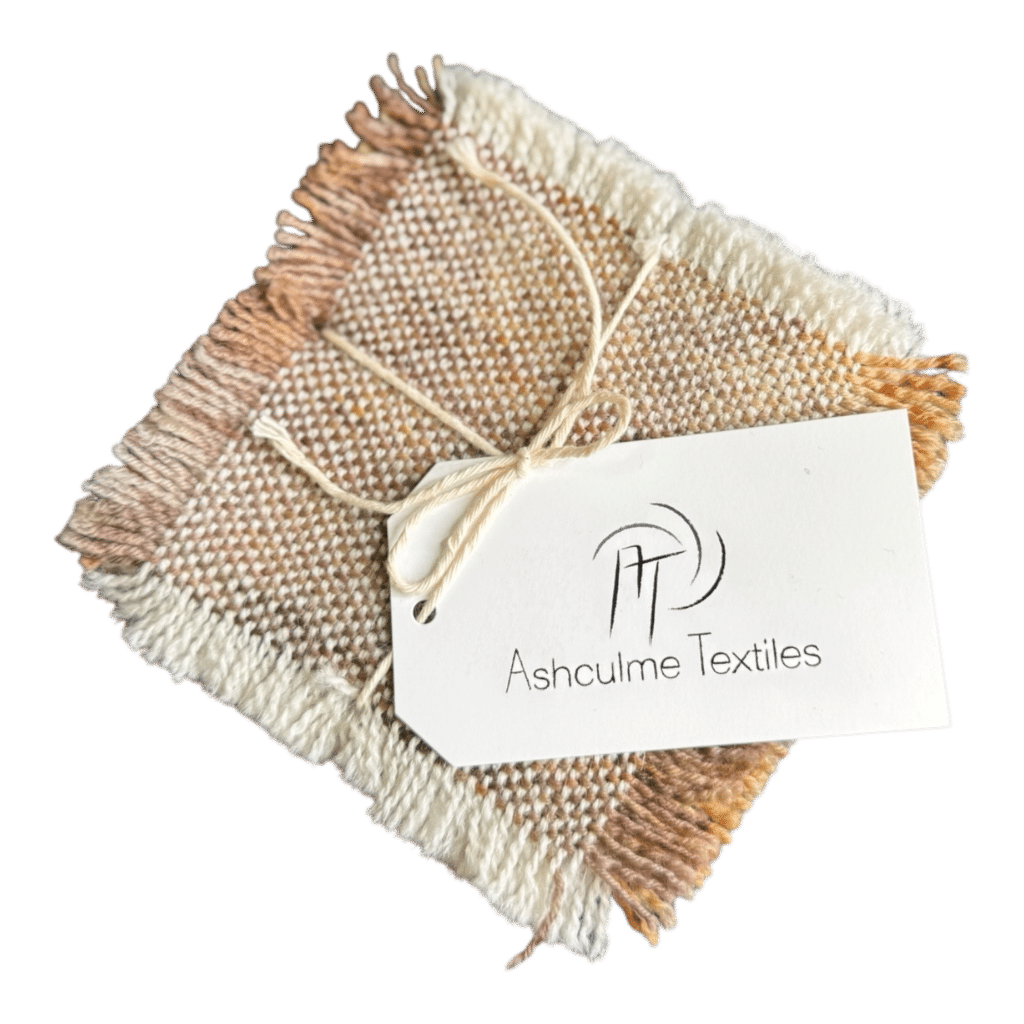 Blush-toned coasters handwoven in alpaca and merino. Naturally dyed with foraged plants. Set of four from Ashculme Textiles - Peach Blossom coasters.