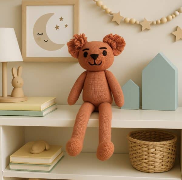 Rosie Roo is a handwoven teddy bear made from alpaca and merino wool, dyed in coral pink and full of charm.