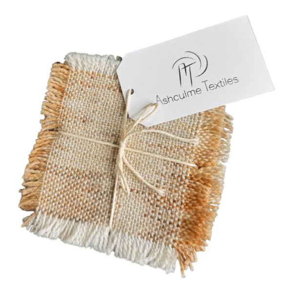 Cream and gold-toned handwoven coasters in alpaca and merino. Naturally dyed with foraged plants. Set of four - Golden Cream coasters.