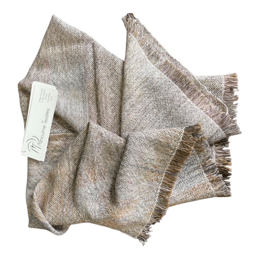 Handwoven merino and alpaca poncho in earthy natural tones, dyed with foraged plants. Soft, warm, and made for layering in all seasons.