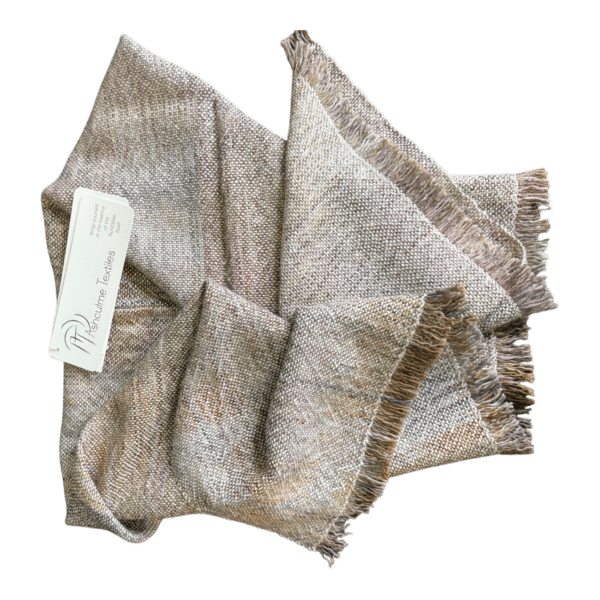 Handwoven merino and alpaca poncho in earthy natural tones, dyed with foraged plants. Soft, warm, and made for layering in all seasons.