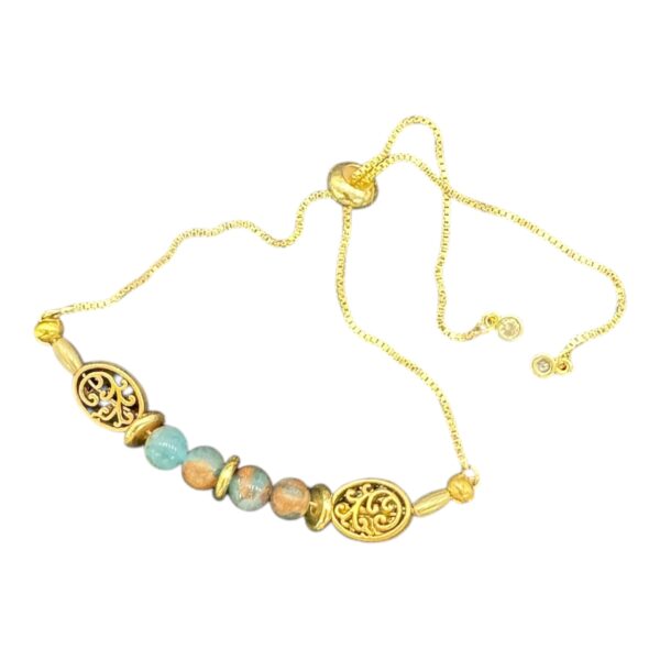 Golden Grove Bracelet by Art in Stone — handcrafted with crystals, semi-precious stones, filigree charms, and CZ details. Adjustable and unique!