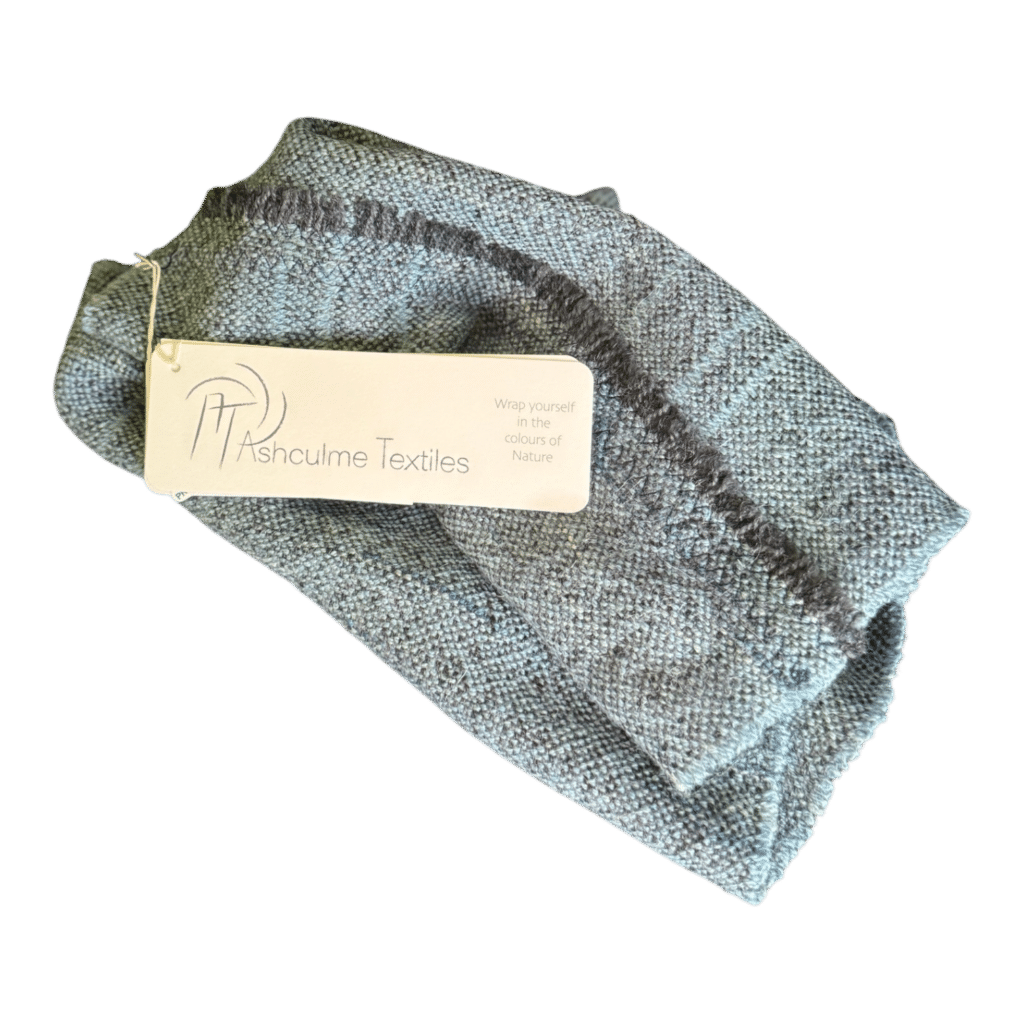 Handwoven merino and alpaca cowl in misty grey-blue tones, dyed with foraged plants. A subtle and stylish wearable for all seasons.