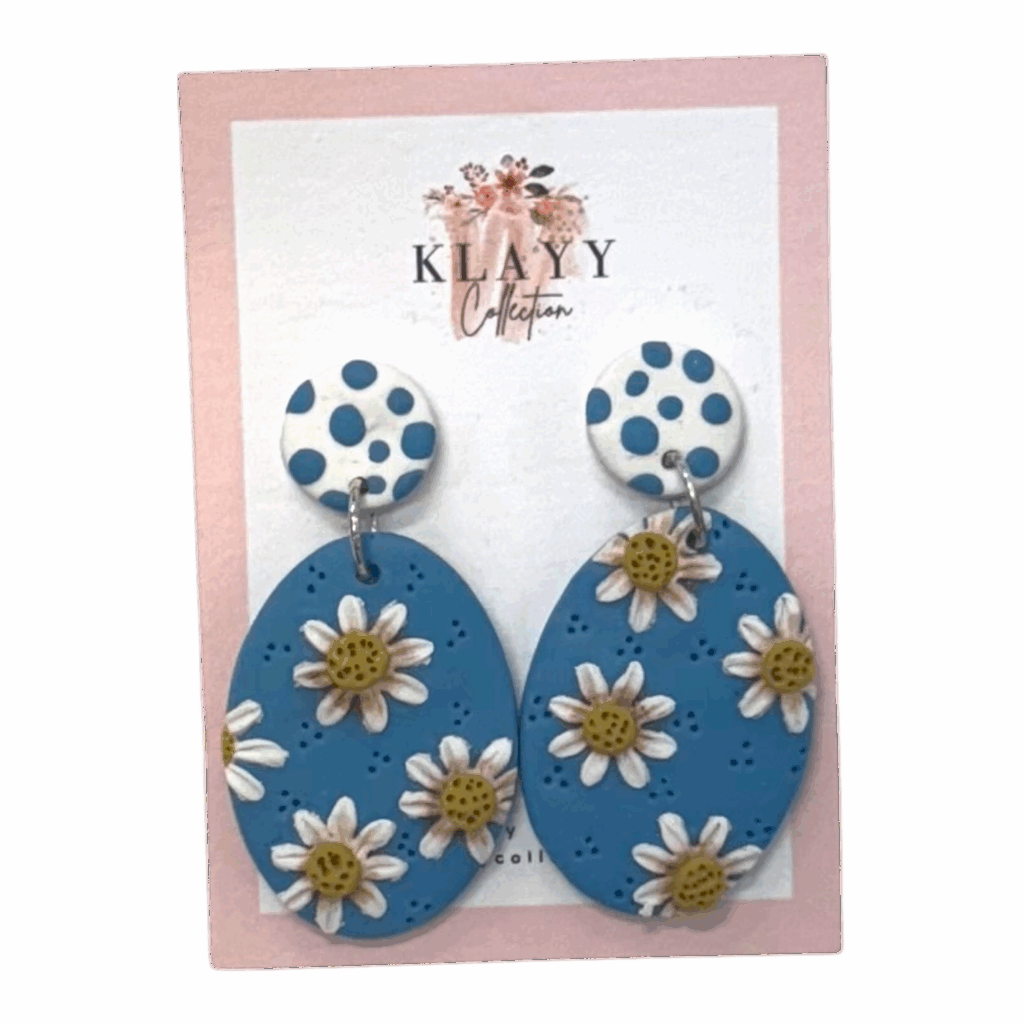 Daisy Days polymer clay earrings by Klayy Collection – fun, handmade blue daisy drops with retro polka-dot tops. Lightweight & full of joy!