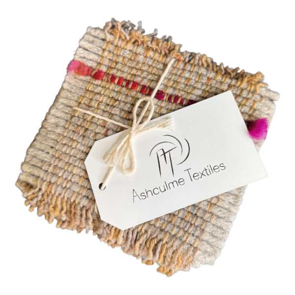 Neutral merino and alpaca coasters with red and plum accents, naturally dyed and handwoven. A one-of-a-kind set of four.