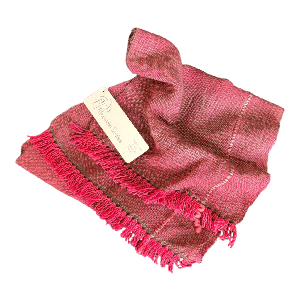 A vibrant pink handwoven scarf in alpaca and merino, featuring bold fringe and natural plant dyes. Lightweight yet warm. By Ashculme Textiles.