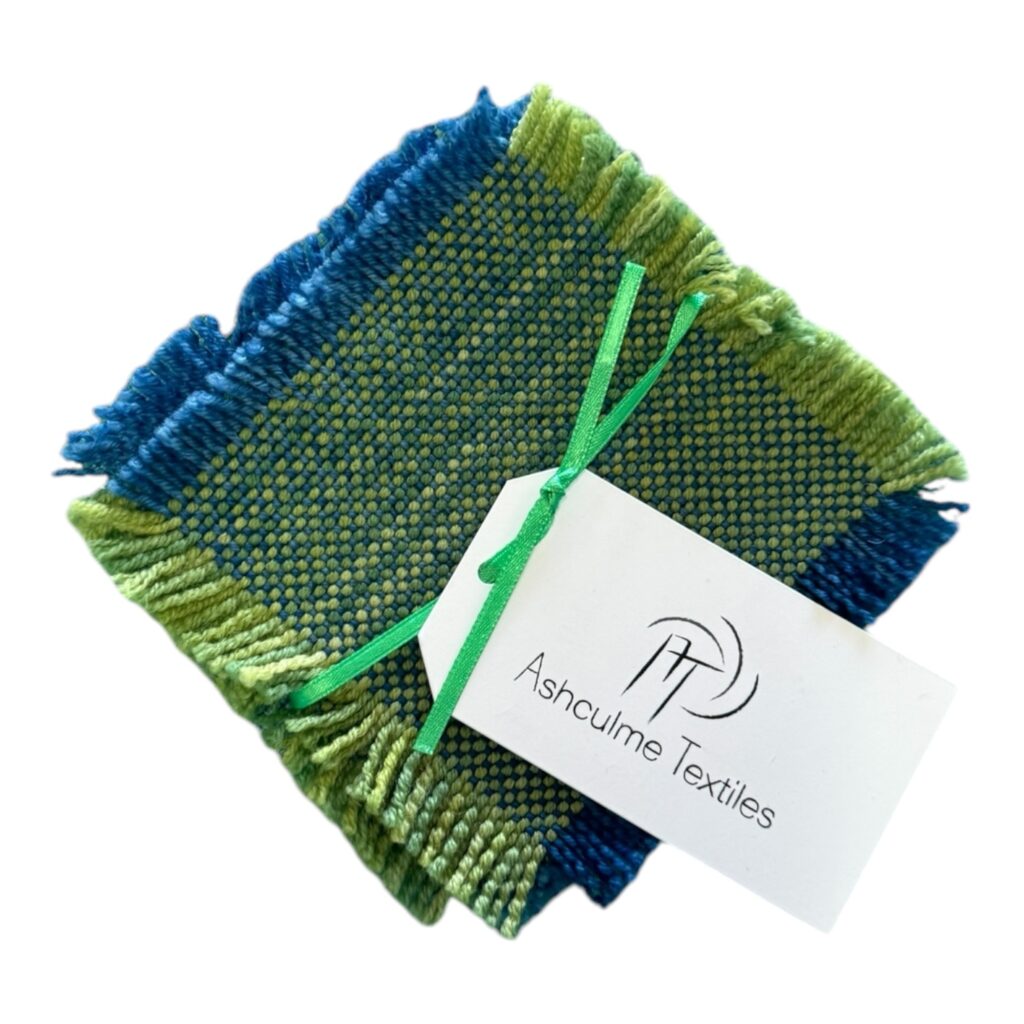 Handwoven green and blue coasters in merino and alpaca wool, naturally dyed with foraged plants. Set of four by Ashculme Textiles - Rainforest Canopy.