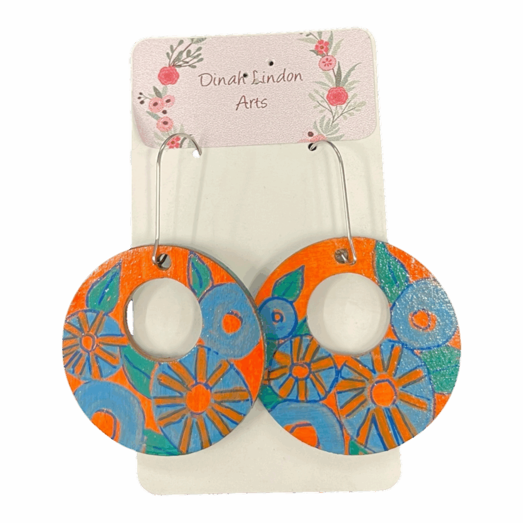 Retro Bloom Hoops by Dinah Lindon – handpainted round earrings with bold blue and orange floral designs on lightweight wood.