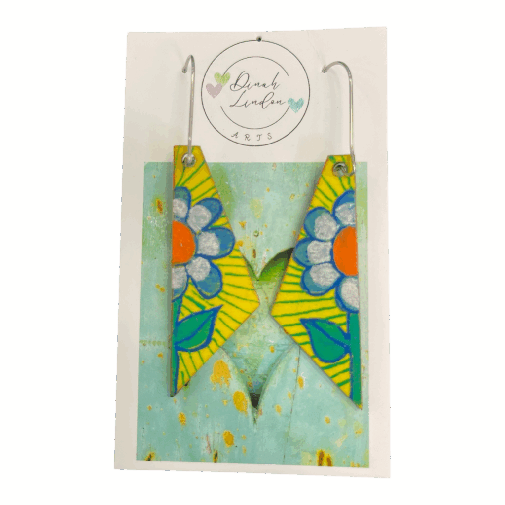 Daisy Stripe Arrows – angular yellow earrings handpainted with bold daisies and vibrant green leaves by Dinah Lindon.