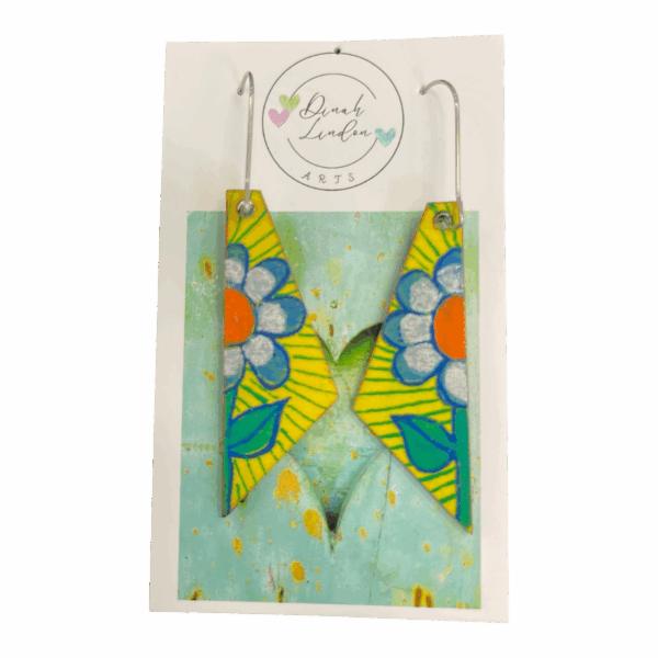 Daisy Stripe Arrows – angular yellow earrings handpainted with bold daisies and vibrant green leaves by Dinah Lindon.