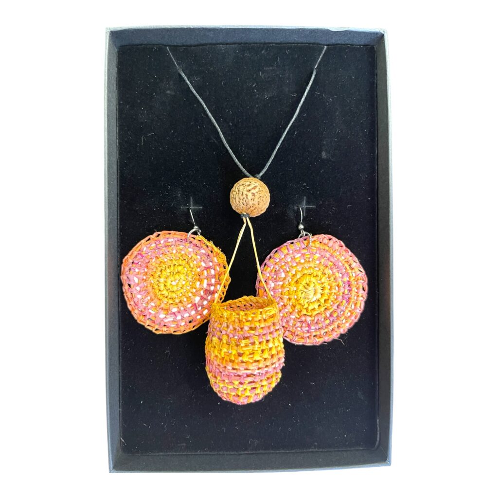 Desert Sunset Set by Gomeroi artist Debbie Wood. A bright raffia basket necklace with matching earrings in sunset pinks and yellow.