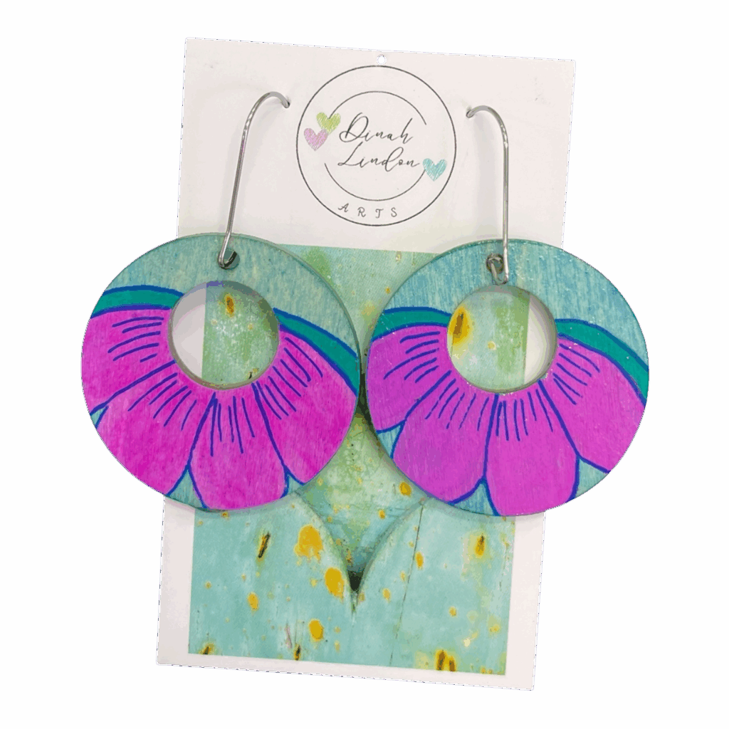 Petal Power Hoops – large round earrings featuring bold purple petals over a turquoise base, handpainted and gloss sealed by Dinah Lindon.